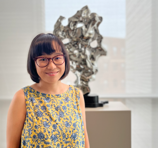 Headshot of Yuhua Ding with a scultpure in the background